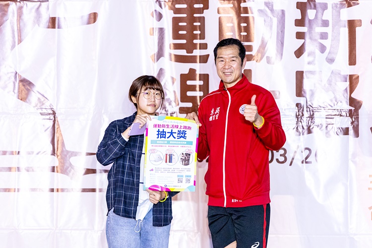 圖片標題:11學生組大獎iPhone13由國貿系楊同學獲獎，體育室東方介德主任頒獎